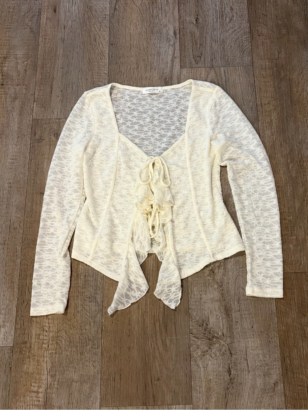 Cream lace long sleeve flowy top with tie detail. Size M